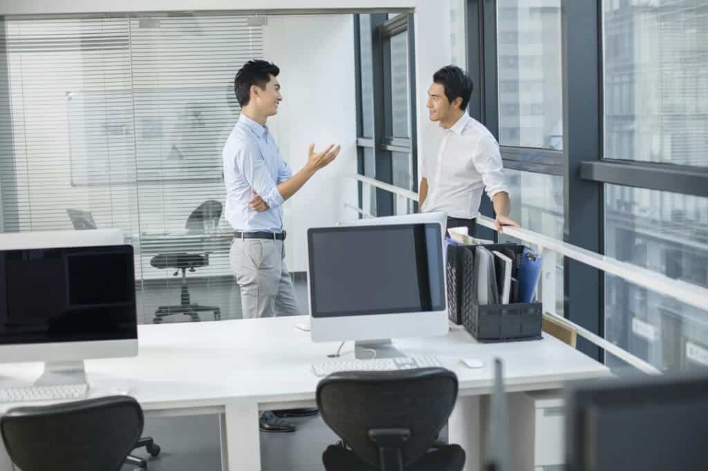 Young businessmen talking in office